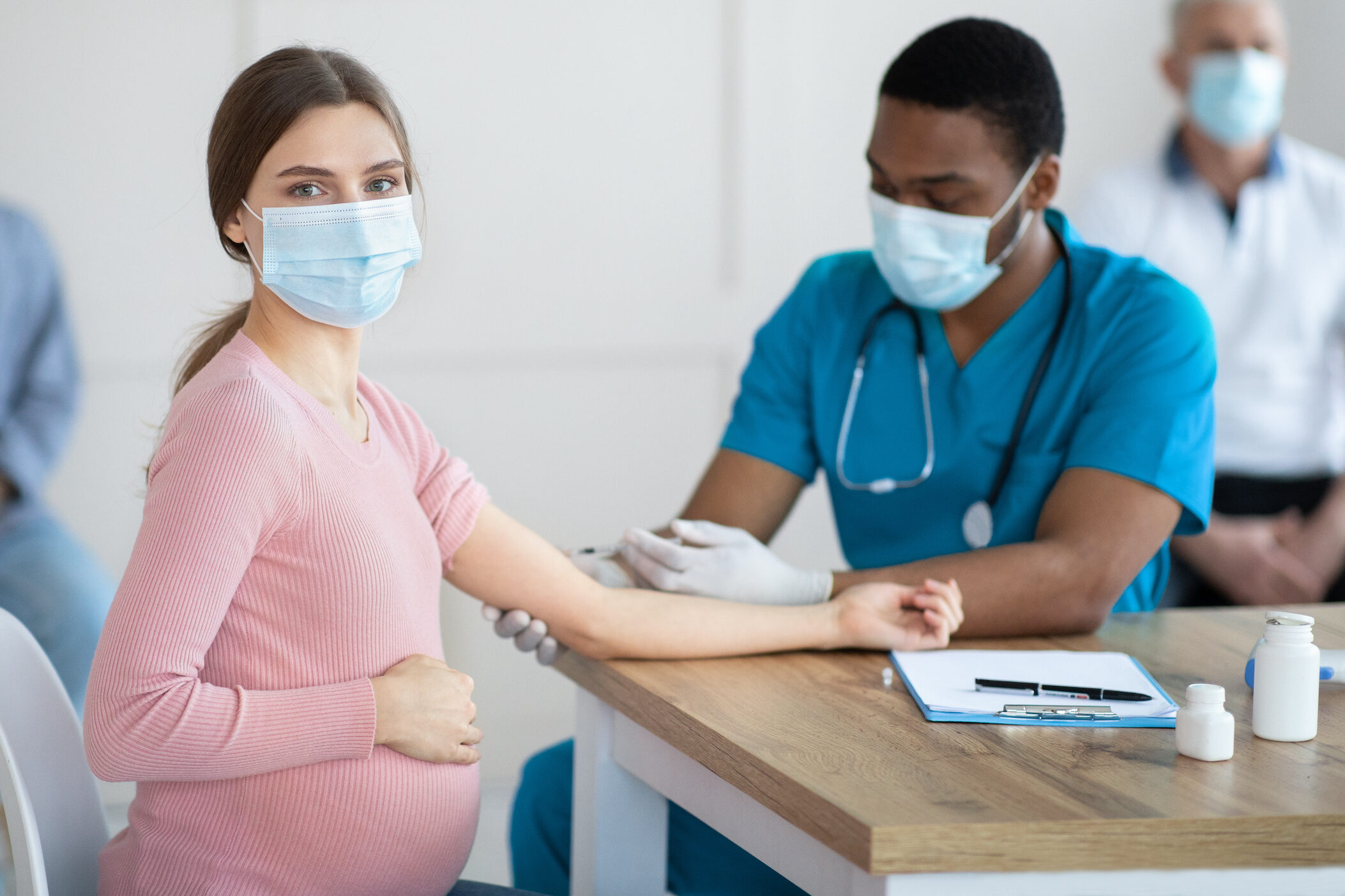woman-in-face-mask getting vaccinated against-Covid-19 at clinic